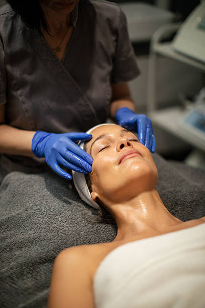 Portrait of a woman having a relaxing face and neck massage at a modern beauty spa.