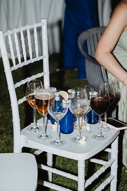 istock Chair with glasses and half-drunk bottles at night 2254083783