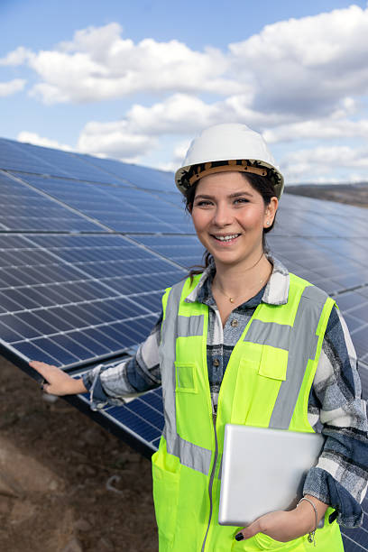 istock Female Renewable Energy Engineer Using Tablet With AI Powered Solar Panel Monitoring System at Solar Power Plant 2254084825