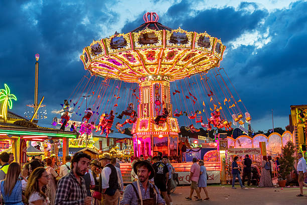 Colorful light streaks from a carnival ride creating abstract patterns and dynamic motion blur against a dark background, capturing energy and speed