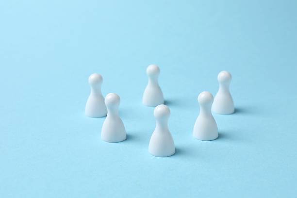istock Group of colored pawns on the table. Concept of unity 2254090517