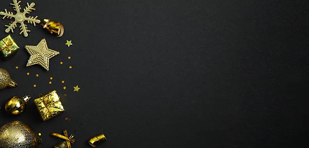 istock Golden confetti with Christmas decorations on black background, top view, space for text 2254090950