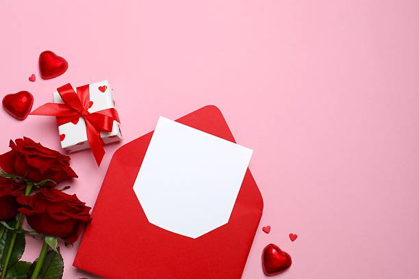 istock Beautiful red roses, gift box, envelope and hearts on pink background 2254091958