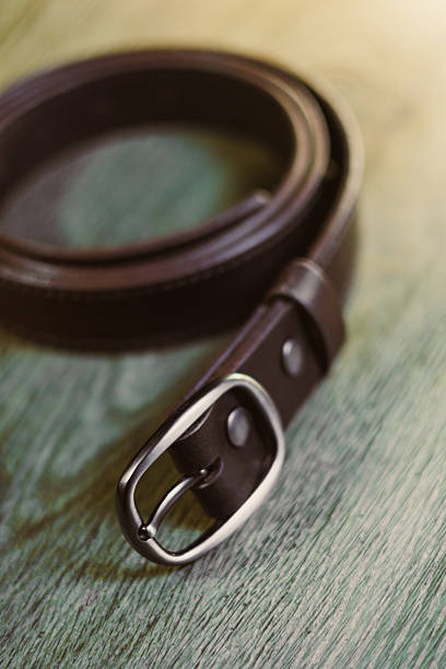 istock Stylish Brown Leather Belt Placed Beautifully on a Wooden Surface This Accessory is Perfect for Both Men and Women A Versatile Fashion Item That Complements Any Outfit with Elegance 2254092807