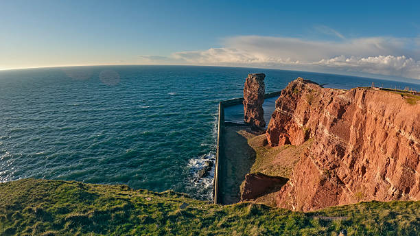 View of cliffs with green areas during sunset