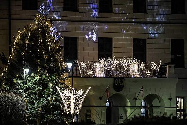 istock Festive Christmas tree and building illuminated with holiday lights at night 2254094376