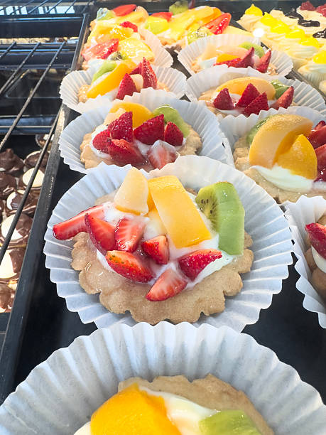 Fresh fruit tarts and pastries on bakery retail display