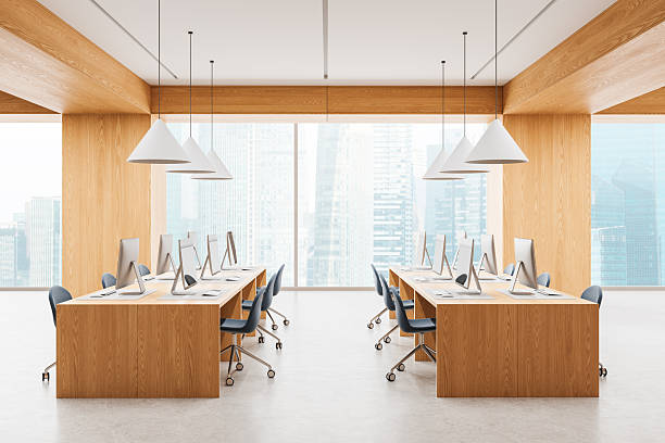 istock Modern open space office interior with wooden desks, ergonomic chairs, and computers in high-rise building with large city view windows. 3D Rendering. 3D Rendering 2254098503