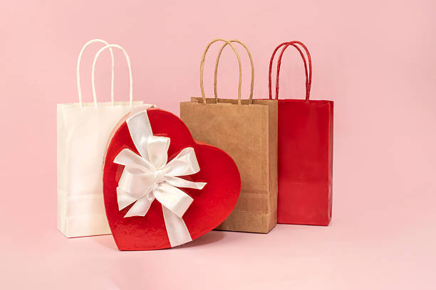 istock A festive backdrop with heart-shaped cardboard boxes with bows and gift bags 2254098985