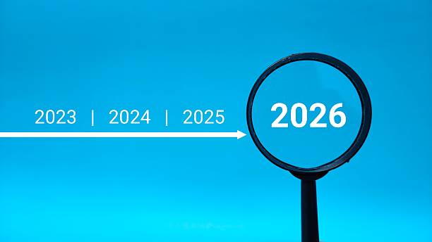 istock 2026 inside of Magnifying glass on blue background. Focus current year, achievement, target concept 2254099175