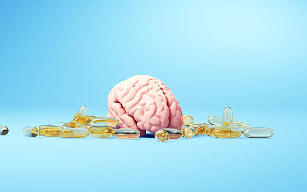 istock Human Brain Surrounded by Capsules on Blue Background 2254102831