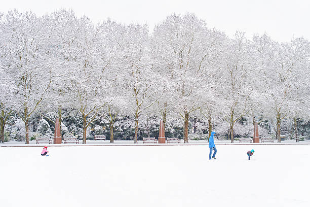 Bellevue Washington - Febrary 6th 2017, Family playing on snow field of Downtown Bellevue Park, Bellevue, Washington.