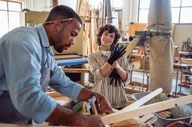 istock Focused Multiracial Carpenters Collaborating in a Bright Workshop with Precision and Teamwork 2254104154