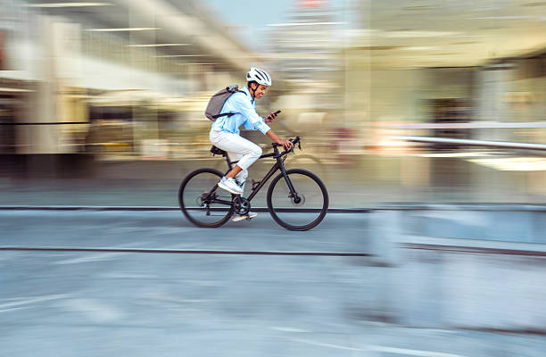 istock Multiracial Woman Cycling to Work While Checking Smartphone 2254104212