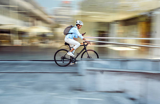 istock Multiracial Female Cycling to Work While Engaging with Smartphone 2254104214