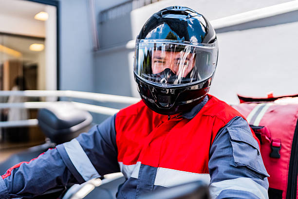 Rescue worker man riding a motorcycle outdoors