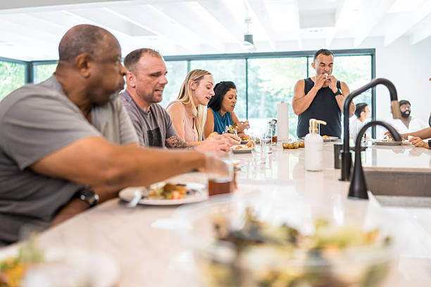 istock Diverse Group Gathers for Meal in Rehab Facility 2254106638