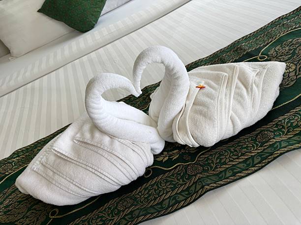 Swan towels forming a heart shape in luxury hotel