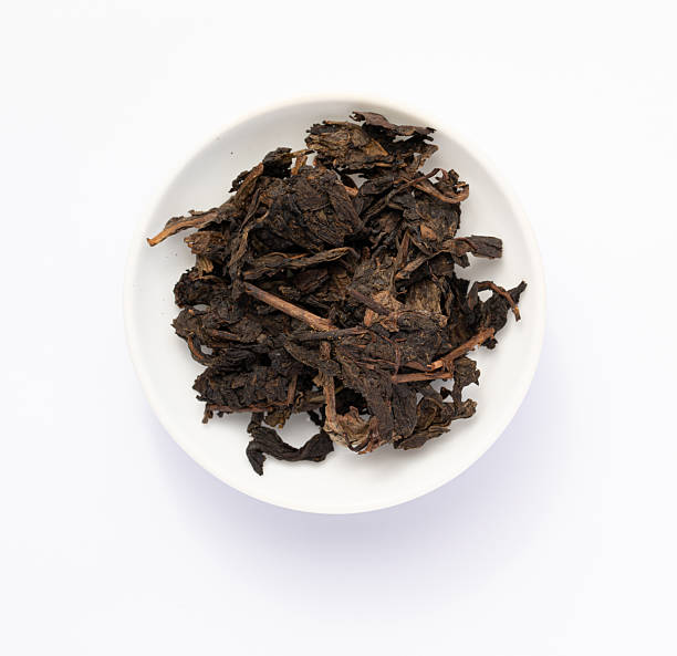 istock Tea sample in white dish. Black tea sample. Tea leaves on white background. black tea leaves on a white background 2254108881