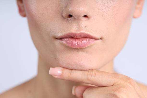 A mole with hair on female face. Closeup