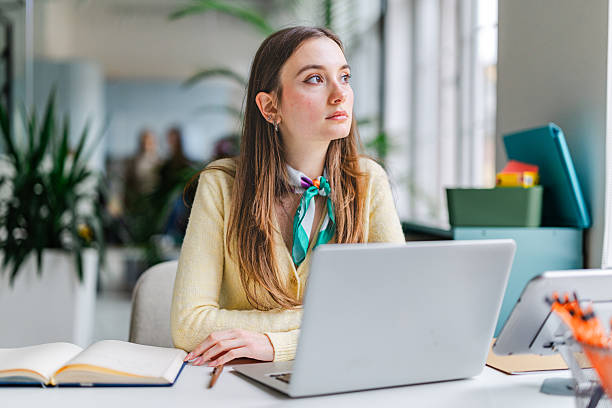 istock Businesswoman at work in a modern office setting focused on her tasks with technology nearby 2254109902