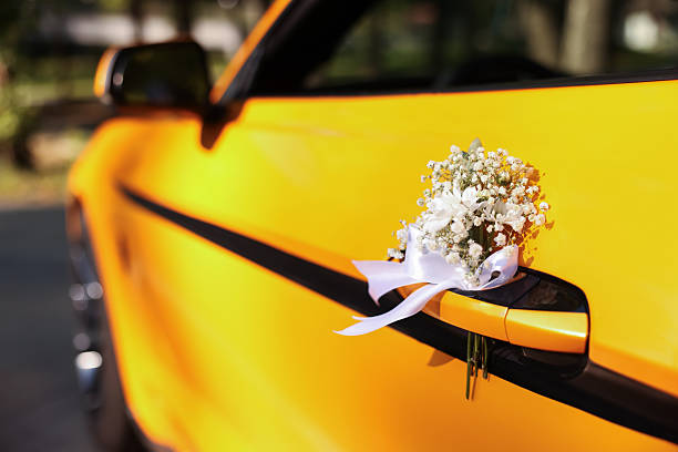 Red ribbon decoration on wedding car