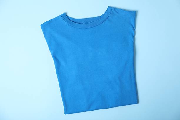 T-shirt on light blue background, top view. Mockup for design