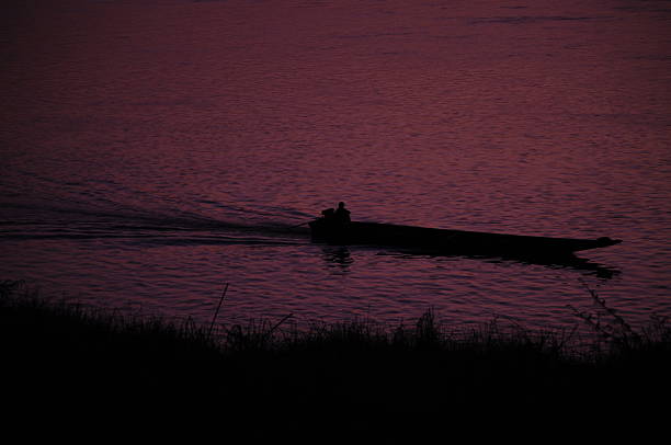 Purple Twilight Sky Over Calm River and Mountain Silhouette