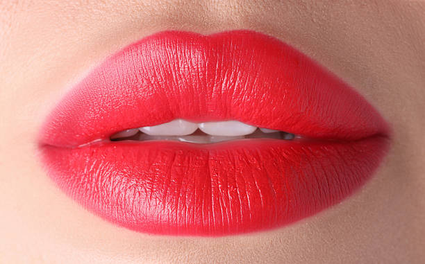 istock Woman with beautiful red lipstick on her lips, macro view 2254112041