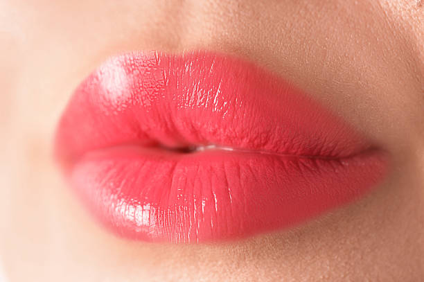 istock Woman with beautiful lipstick on her lips, macro view 2254112110