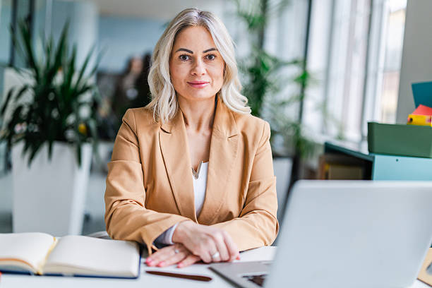 istock Businesswoman working in a modern office setting with technology and plants around her 2254112151