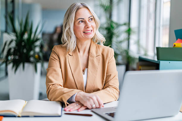 istock Businesswoman works in office during daylight hours while managing tasks and collaborating with colleagues 2254113395