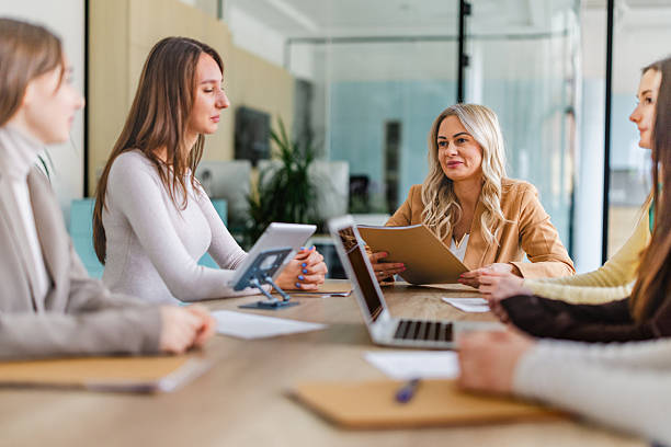 istock Businesswomen collaborate in a modern office setting during a team meeting focused on project planning and strategy development 2254114295