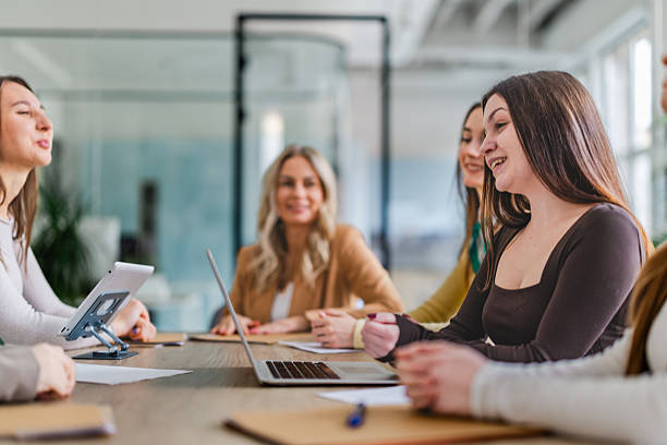istock Businesswomen collaborate in a modern office space while discussing projects and sharing ideas in a cooperative atmosphere 2254114417