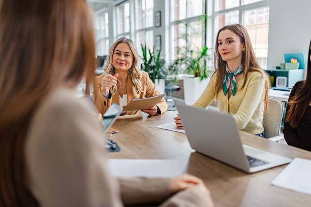 istock Businesswomen collaborate in an office setting discussing important matters with focus and teamwork 2254114535
