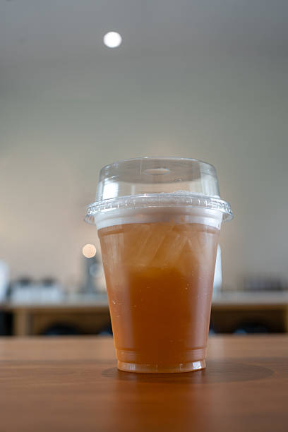 Iced lime tea with cream cheese on top in plastic glass