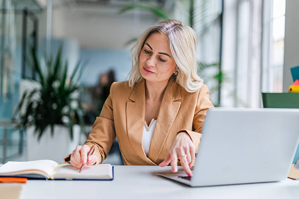 istock Businesswomen work in an office as they use technology while collaborating and engaging in their tasks together 2254117436