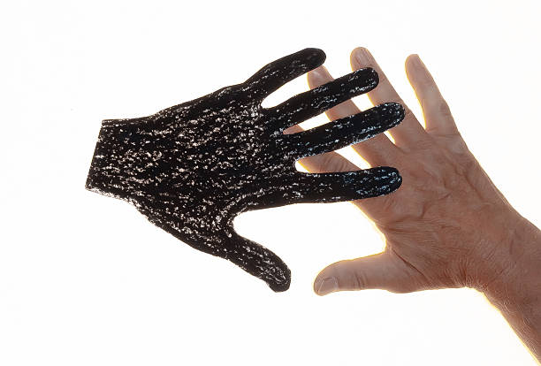 Two hands, one real human, the other one paper cut out, holding each other