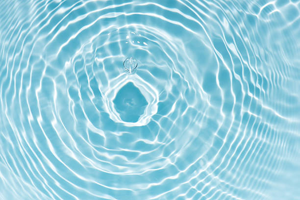 istock Bluewater waves on the surface ripples blurred. Defocus blurred transparent blue colored clear calm water surface texture with splash and bubbles. Water waves with shining pattern texture background. 2254120464