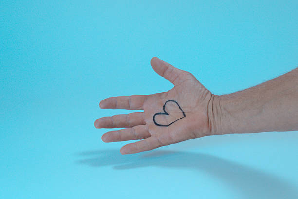 Human hand with a heart symbol inprinted on the palm
