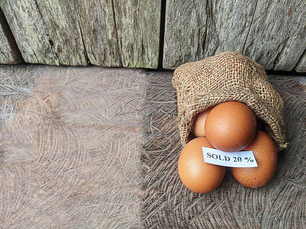 Chicken eggs in a burlap bag with a sale