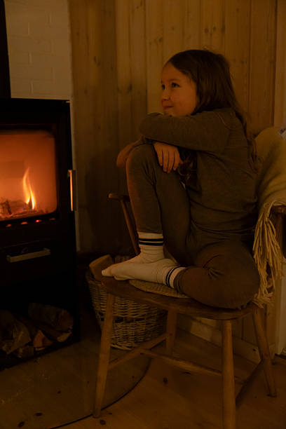 istock Female at fireplace 2254124297