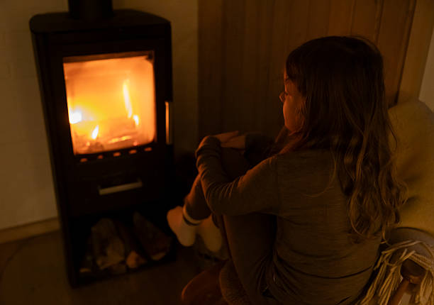 istock Female at fireplace 2254124298