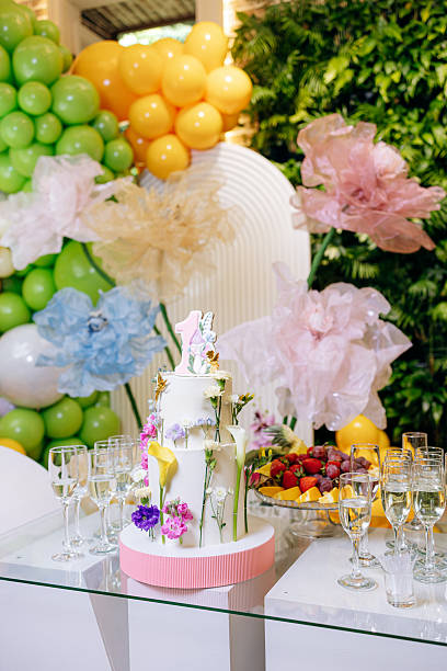 istock An Elegant Celebration Cake, adorned with vibrant and colorful balloon decorations and complemented by a fresh and delightful fruit platter, perfect for any festive occasion or gathering 2254126984