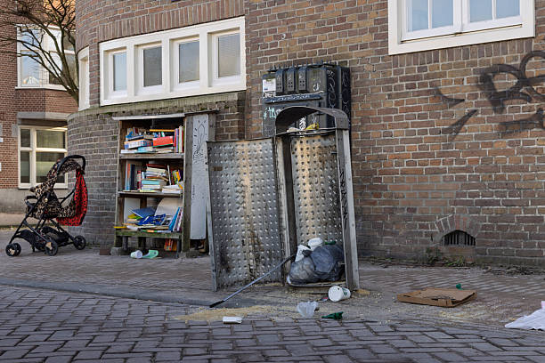 A garbage bin has been opened for deposits on cans and bottles. Trash is strewn across the streets of Amsterdam Netherlands, 28 december 2025