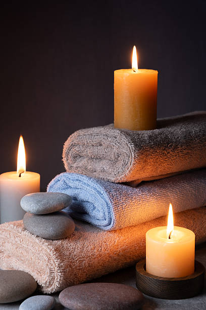 istock Spa still life with towels, candles and stones on dark background. 2254131914