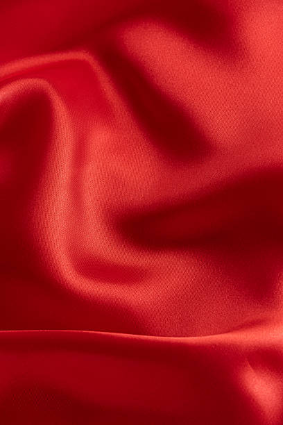istock Closeup of rippled red satin fabric texture background. 2254131926