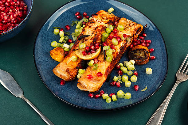 istock Two grilled salmon steaks on a wooden table. 2254132387