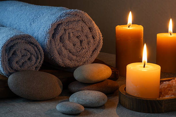 istock Spa still life with candles, stones and towels on grey background. 2254137714