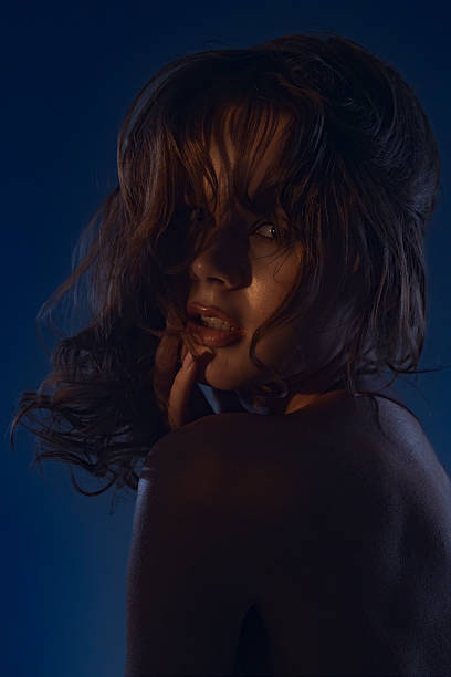 istock Mysterious Woman in Dramatic Lighting Portrait 2254137884